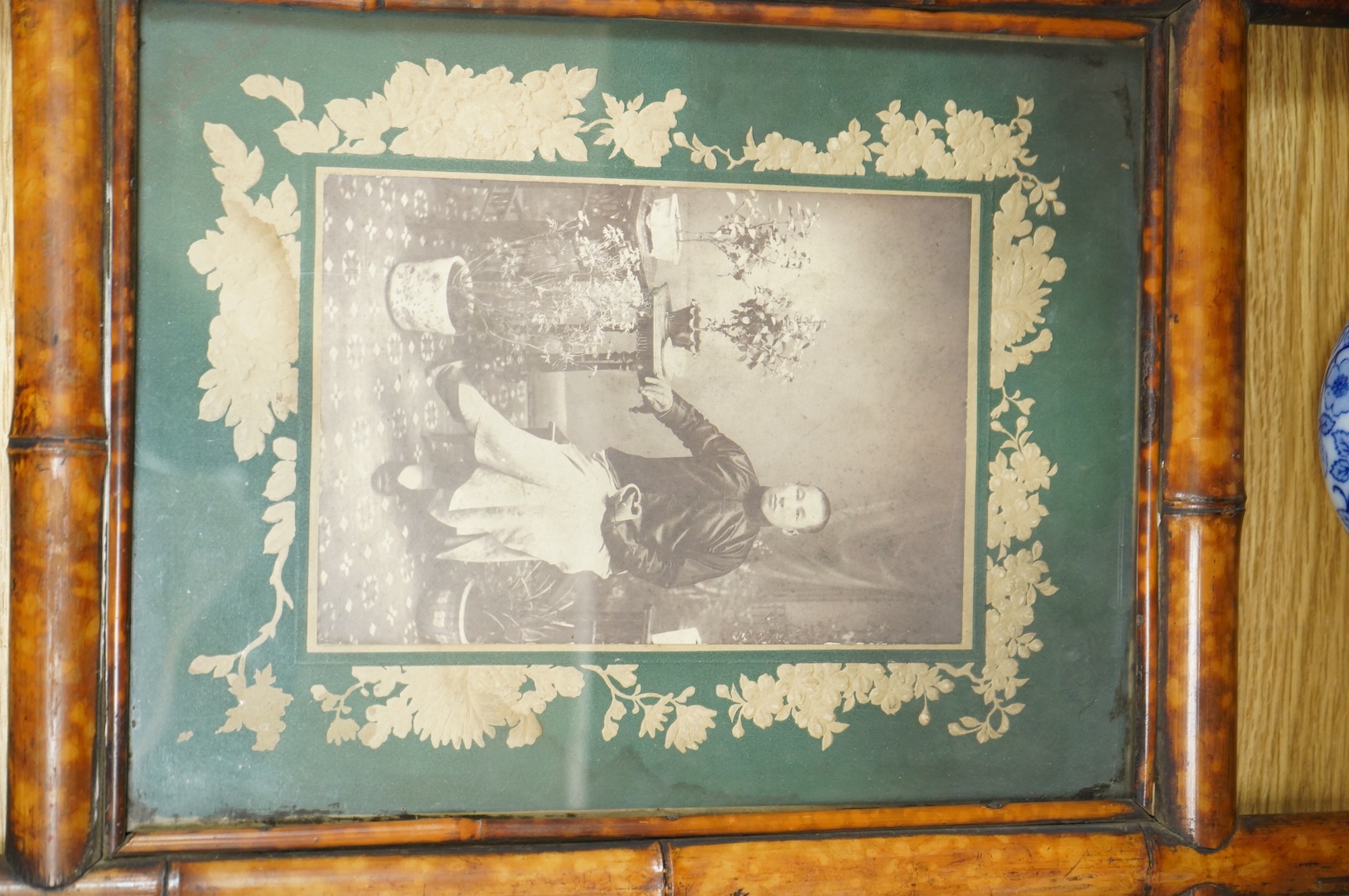 A MacIntyre Burslem blue and white teapot, c.1900, 15cm high and an early 20th century Chinese portrait photograph in a bamboo frame